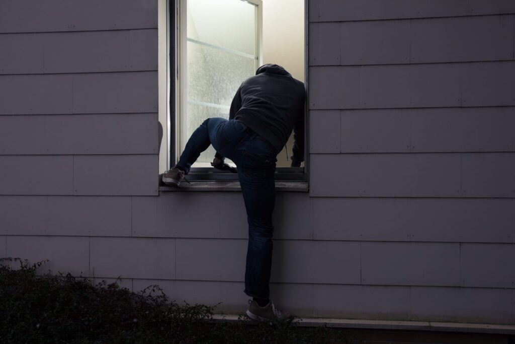 Burglar Crawling Through Window