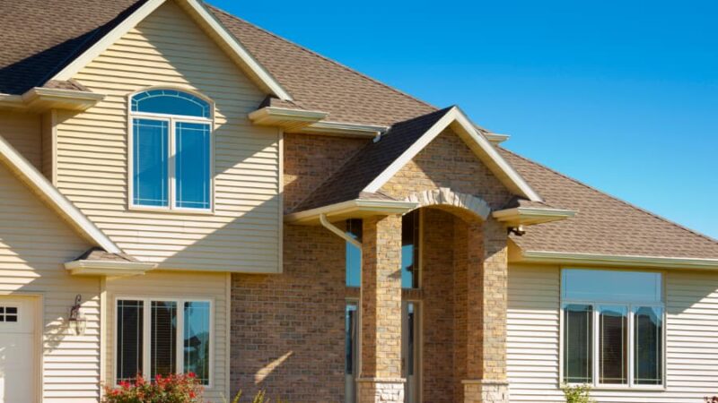 Exterior of home front entryway with brown siding